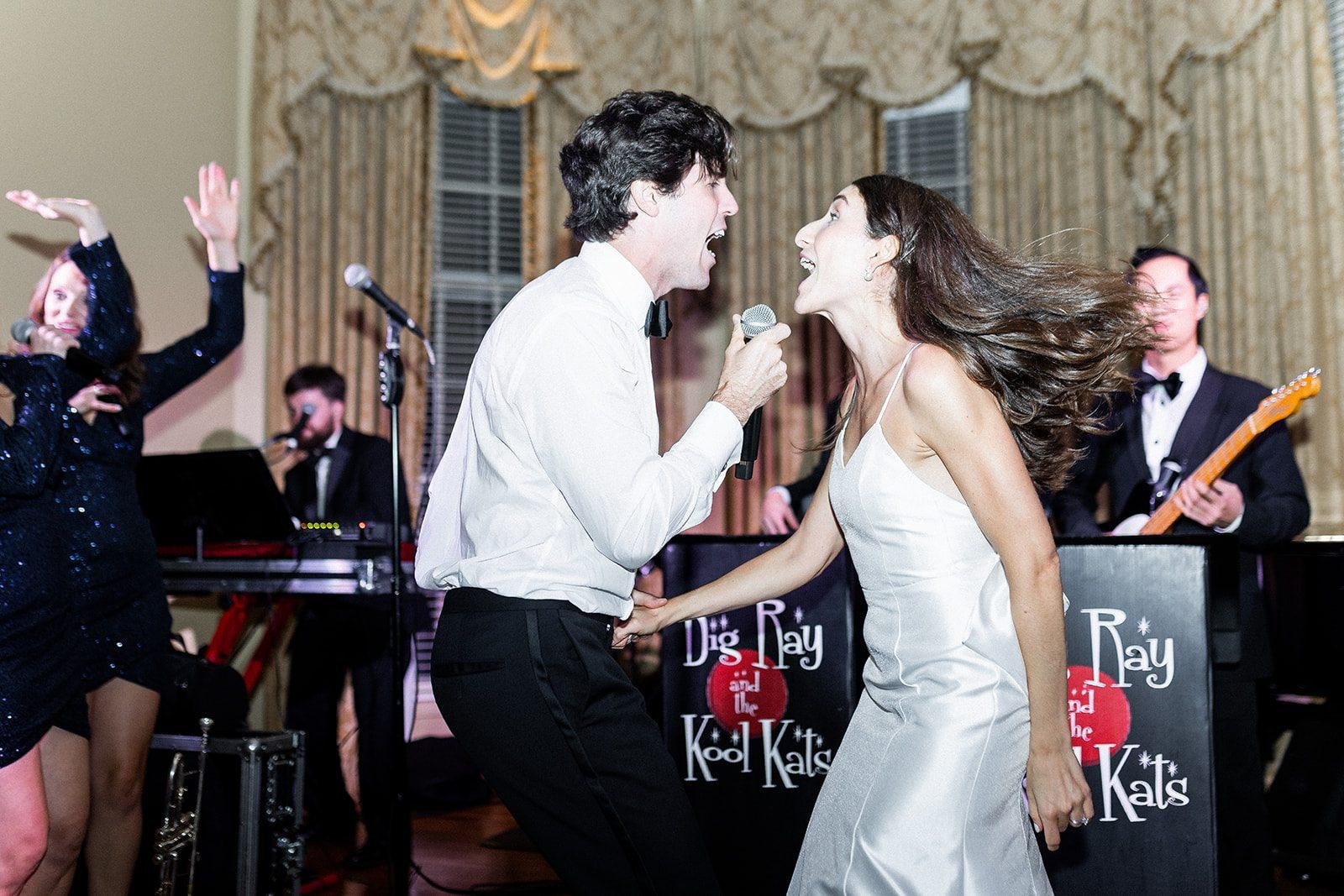 Big Ray and the Kool Kats bride and groom on stage singing